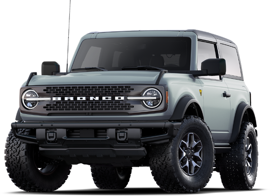 Rugged off-road SUV with a gray body and large all-terrain tires. Distinct front grille featuring bold "Bronco" lettering, conveying strength.