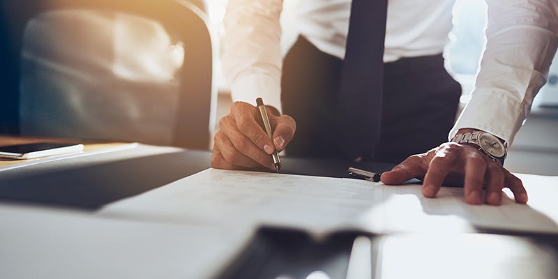 Korum Ford in Puyallup WA customer signing financing paperwork